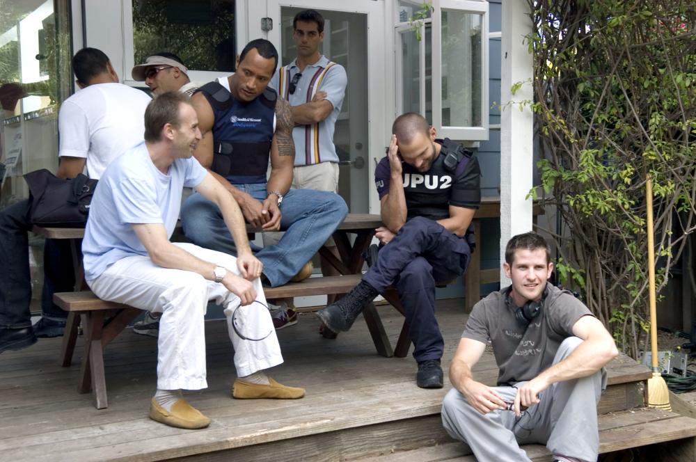 SOUTHLAND TALES, foreground: The Rock (second from left), Seann William Scott (third from left), director Richard Kelly (far right), on set, 2006. ©Universal