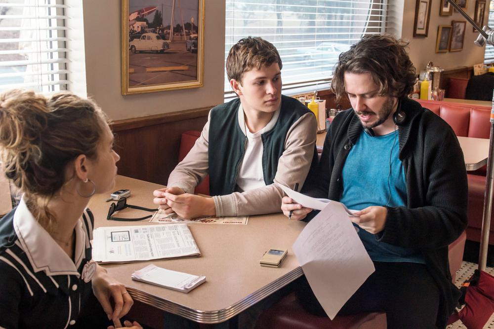 BABY DRIVER, FROM LEFT, LILY JAMES, ANSEL ELGORT, DIRECTOR EDGAR WRIGHT, ON-SET, 2017. PH: WILSON WEBB. ©TRISTAR