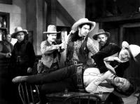 ARIZONA DAYS, Glenn Strange (center, being held back), Tex Ritter (choking villain on table), 1937