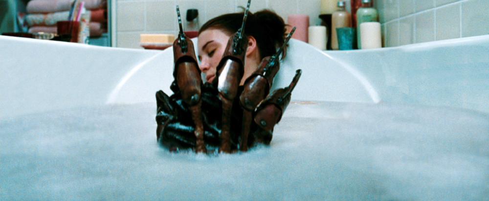 A NIGHTMARE ON ELM STREET, Jackie Earle Haley (hand), Rooney Mara (back), 2010. ©Warner Bros