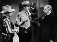 OUTLAWS OF THE ROCKIES, second and third from left: Charles Starrett, Frank LaRue, 1945