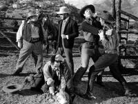 THE KANSAN, Eugene Pallette (far left), Glenn Strange (right standing, taking punch), 1943