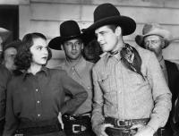 BULLETS FOR RUSTLERS, front from left: Lorna Gray, Charles Starrett, 1940