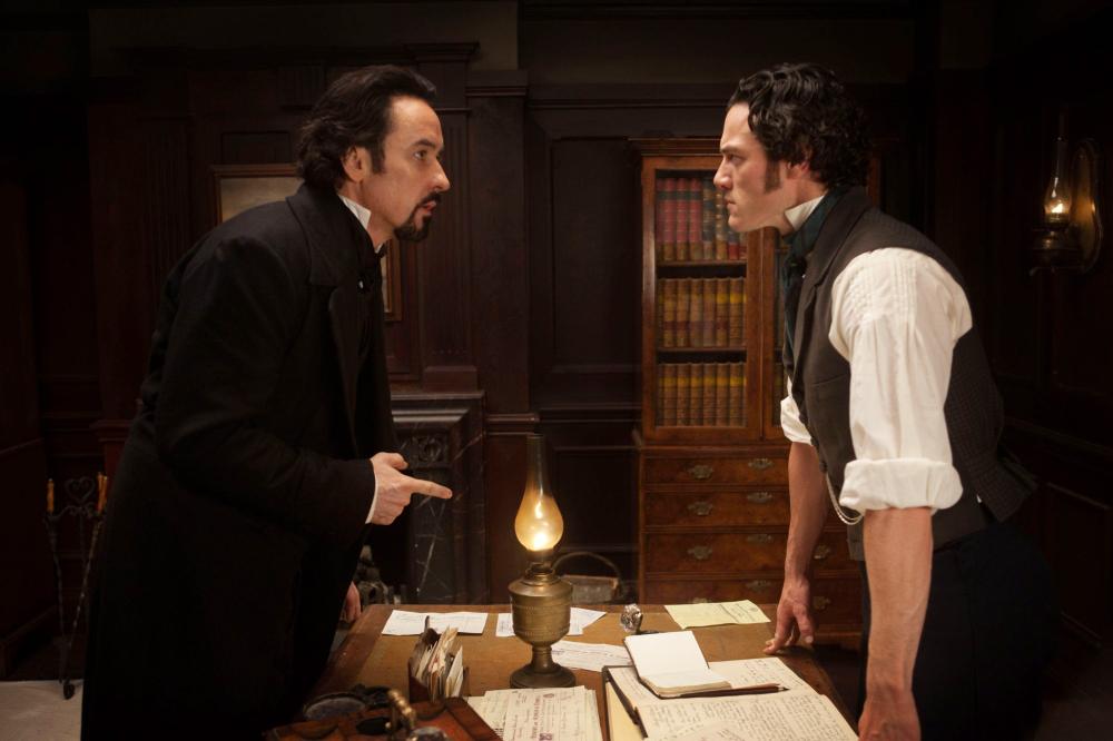 THE RAVEN, from left: John Cusack, as Edgar Allan Poe, Luke Evans, 2012. Ph: Larry Horricks/©Rogue Pictures