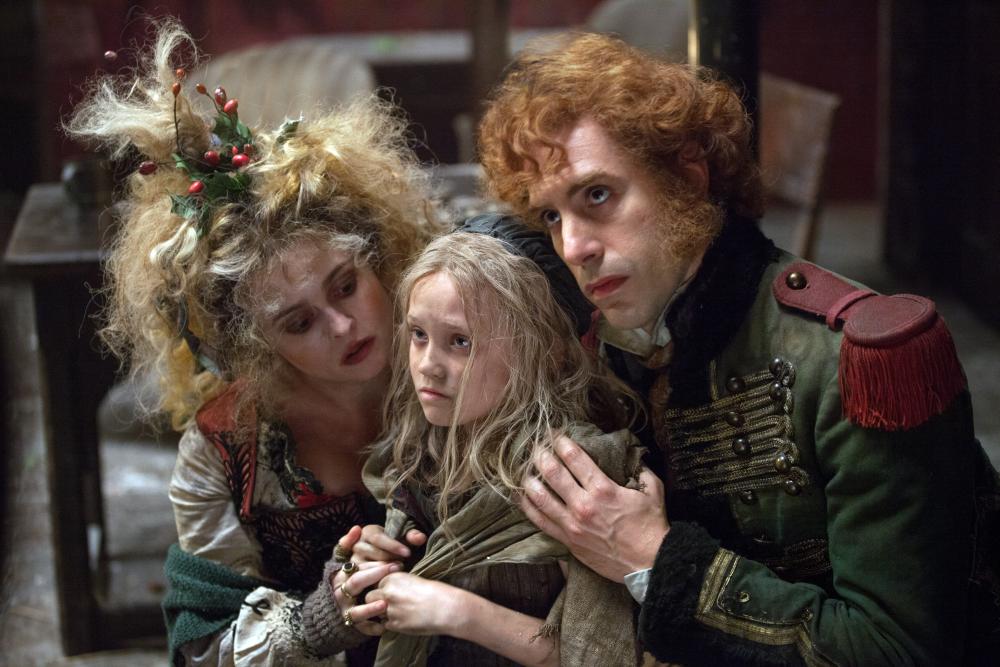 LES MISERABLES, from left: Helena Bonham Carter, Isabelle Allen, Sacha Baron Cohen, 2012. ©Universal Pictures