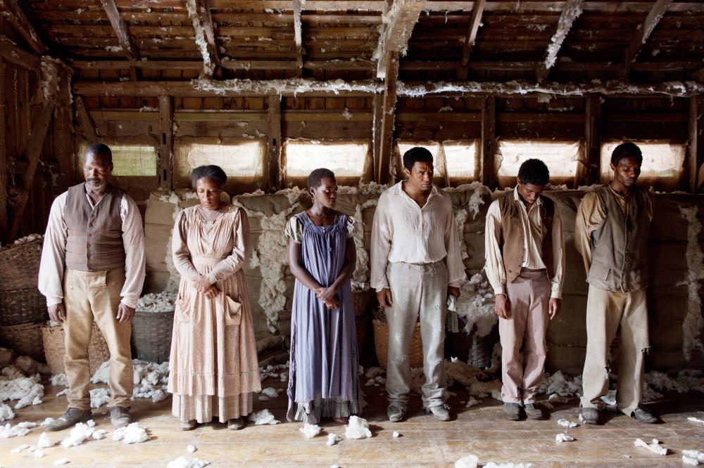 12 YEARS A SLAVE, Lupita Nyong'o (blue dress), Chiwetel Ejiofor (right of center), 2013. ph: Francois Duhamel/TM and Copyright ©Fox Searchlight Pictures. All rights reserved.