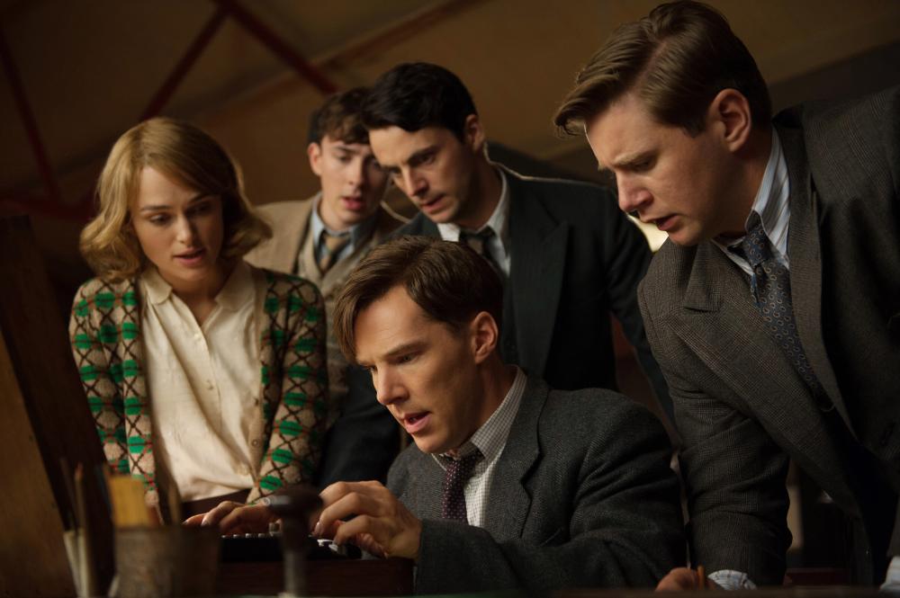 THE IMITATION GAME, seated: Benedict Cumberbatch as Alan Turing; standing from left: Keira Knightley, Matthew Beard, Matthew Goode, Allen Leech, 2014. ph: Jack English/© Weinstein Company