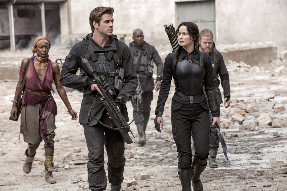 THE HUNGER GAMES: MOCKINGJAY - PART 1, from left: Patina Miller, Liam Hemsworth, Mahershala Ali, Jennifer Lawrence, 2014. ph: Murray Close/©Lionsgate